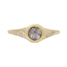 a gold and diamond ring with a stone in the center