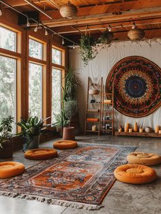 a living room filled with lots of furniture and large rugs on top of a floor