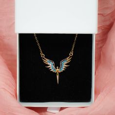 🌌✨ Crafted with care, the 'Zircon Angel Necklace' is more than just an accessory; it's a heartfelt symbol of elegance and sophistication. Each opalescent gem reflects the beauty of connections and the allure of style. Wearing it serves as a gentle reminder of cherished moments and timeless elegance, encapsulating the enduring essence of love in its purest form. 🌌🌸 Crafted with care, the Zircon Angel Necklace' is the perfect choice for any occasion, whether it's birthdays, anniversaries, or si Gift Tarnish Resistant Cubic Zirconia Necklace, Pendant Jewelry With Adjustable Chain For Birthday, Blue Charm Necklace Gift - Tarnish Resistant, Angel Wing Gifts, Angel Wings Necklace, Dainty Gold Chain, Wings Necklace, Gold Angel Wings, Angel Wing Necklace