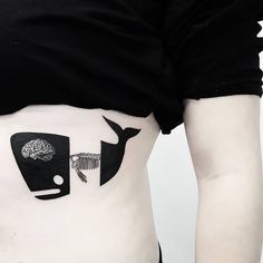 a woman's stomach with an image of a whale and a fish on it