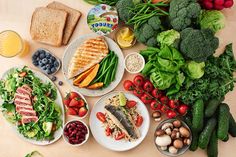 a table topped with lots of different types of foods and vegetables next to each other