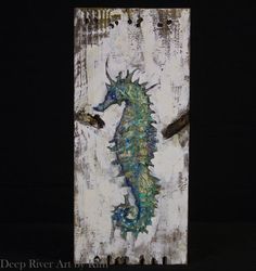 a painting of a sea horse on a piece of wood