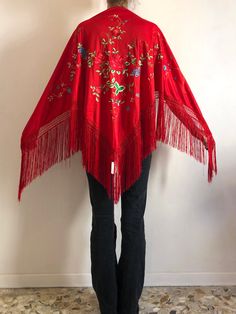 Fun and fringe-tastic 1970s embroidered boho triangular shawl. Very Stevie Nicks! The shawl is made from a poly jersey fabric that has been machine embroidered with sweet multi colored flowers. Fringe border is perfect for shaking and twirling! Label Coscollar Sl, Aldaya Valencia, Espana. 100% polyester please hand wash cool, drip dry. Very good condition. Measurements Across 160cm/ 62inches Depth 76cm/ 30inches Fringe is 26cm/ 10inches Spring Festival Folk Style Shawl, Folk Style Spring Festival Shawl, Folk Style Shawl For Spring Festival, Red Bohemian Shawl With Fringe, Bohemian Fringe Shawl For Spring, Bohemian Embroidered Summer Shawl, Spring Shawl With Tassels, Traditional Spring Shawl, Festival Shawl With Tassels