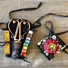 an assortment of crafting supplies laid out on a wooden floor with measuring tape and scissors