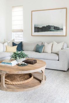 a living room with white couches and a coffee table