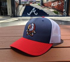 Show off your Atlanta pride with these amazing embroidered Indian headdress trucker hats! These are one of a kind ATL baseball trucker hats! The hats are one size fits all, i.e. snapbacks © 2021 Whiskey Pines LLC Artwork has been copyrighted and may not be reproduced in any form, or for any reason, without express written permission from me. Artwork is fully protected by U.S. and International Copyright laws, all rights reserved. Purchase of artwork does not transfer copyright. Artist retains al Trucker Baseball Cap For Fan Gear, Trucker Snapback Hat With Curved Brim For Fan Gear, Braves Hat, Indian Headdress, Patch Hat, Baseball Trucker Hat, Hat Patches, Indian Head, Hat Baseball