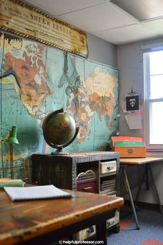 an office with a map on the wall next to a desk and chair in front of it