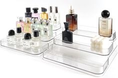 two clear trays with different types of perfume bottles