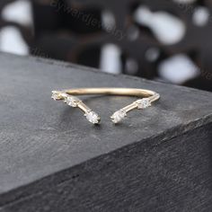 a gold ring with three diamonds on it