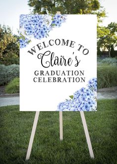 a sign that says welcome to claire's graduation celebration with blue flowers on it