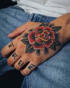 a person with a rose tattoo on their hand