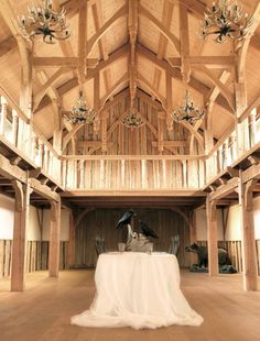 the inside of a large wooden building with chandeliers