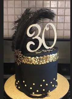 a black and gold birthday cake with the number thirty