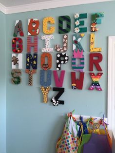 the letters are made up of different shapes and sizes on the wall in this child's room