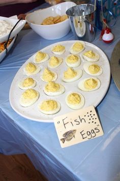 an egg tray with eggs on it and other food items in bowls around the table