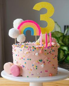 a birthday cake with pink frosting and sprinkles