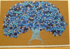 a blue tree made out of buttons on a bulletin board with a corkboard frame