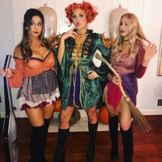 three women dressed up as witches posing for the camera