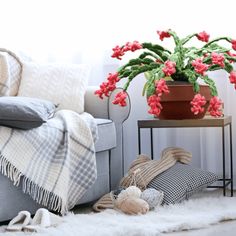 a living room filled with furniture and a potted plant