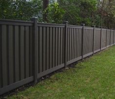 a black fence in the middle of some grass