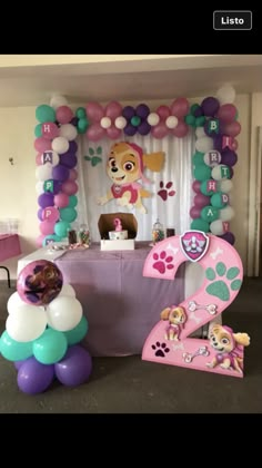 a table with balloons and decorations for a paw patrol birthday party