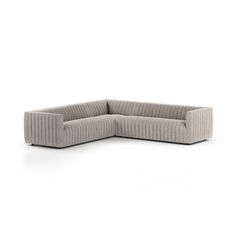 the corner sofa is made out of fabric and has a rounded backrest, with an extended