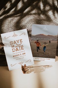 two wedding save the dates cards sitting on top of a table next to each other