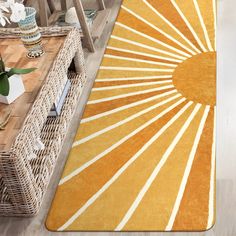 an orange and white rug on the floor in front of a wicker table with vases