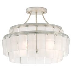 a white chandelier hanging from a ceiling fixture with shades of light on it