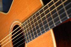 an acoustic guitar sitting on top of a table