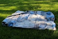 a blanket laying in the grass on top of it