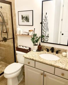 a bathroom with a sink, toilet and shower in it's center piece is shown