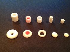 there are several different types of plastic objects on the table together, including one red and one white object