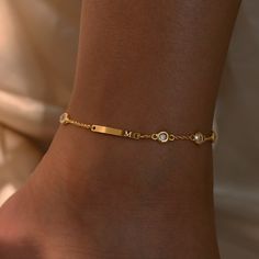 "Add a personalized touch to your ankle with our 16k gold Custom Name Bar Anklet. This anklet features a sleek name bar plate that can be engraved with your chosen initial, creating a truly unique piece. Crafted with attention to detail and plated in luxurious 16k gold, it exudes elegance and style. #YOU MAY LIKE THIS 16K Gold Heart Anklet Summer Beach Anklets https://www.etsy.com/listing/1512151985/16k-gold-heart-anklet-summer-beach 6K gold Personalized Heart Name Anklet https://www.etsy.com/li Gold Initial Bracelet, Personalized Adjustable Elegant Anklet, Elegant Personalized Adjustable Anklet, Personalized Gold Elegant Anklets, Elegant Gold Personalized Anklets, Elegant Personalized Gold Anklets, Anklets Aesthetic, Anklets Gold, Name Anklet