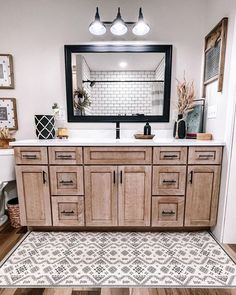 a bathroom with a large mirror and wooden cabinets