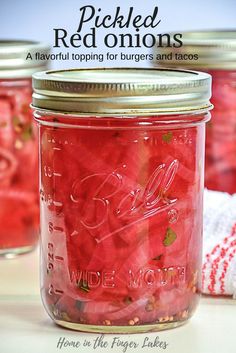 pickled red onions in a mason jar with text overlay reading pickled red onions a flavor topping for burgers and tacos