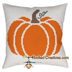 a cross stitch pillow with a pumpkin on it