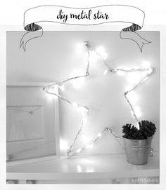 a black and white photo of a star on a shelf with lights in the corner