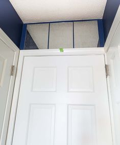 a white door with blue trim in a room