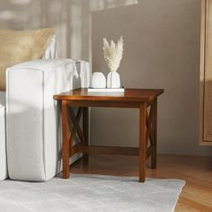 a white couch sitting next to a wooden table