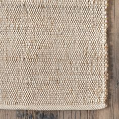 an area rug on top of a wooden floor