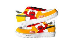 a pair of yellow and red sneakers with elmo painted on the upper part of them