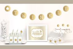 a table topped with white and gold desserts next to a sign that says twinkle