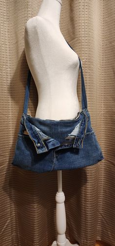 a white mannequin wearing a blue jean skirt