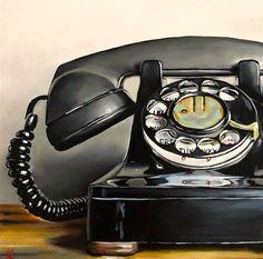 an old fashioned telephone sitting on top of a wooden table next to a white wall