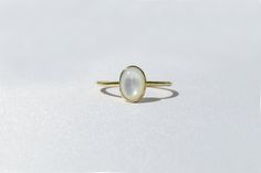 Elegant, simple and truly a classic piece. This mother of pearl ring is made from 14k solid gold or 14k solid white gold material. Set with a natural mother of pearl stone. Each pearl is unique and natural. Whether you're buying this beautiful pearl ring as a gift or for yourself, it will bring forth new beginnings and good luck. Handmade in Los Angeles, CA! Fast Shipping: It will take 1-3 business days to send out your item Packaging: Comes in an upgraded gift box, ready for gift-giving! Pearl Timeless Oval Rings With High Luster, High Luster Oval Ring In 14k Gold, High Luster 14k Gold Oval Rings, Timeless Round Moonstone Ring Gift, Timeless Round Moonstone Ring As Gift, Elegant Moonstone Rings With Polished Finish, Minimalist Yellow Gold Moonstone Ring In Sterling Silver, Minimalist Round Moonstone Ring With Polished Finish, Minimalist Yellow Gold Sterling Silver Moonstone Ring