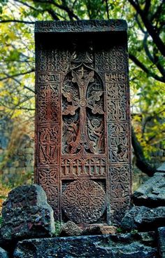 an intricately carved stone in the woods