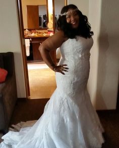 a woman in a wedding dress posing for the camera