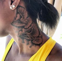 a woman with a bird tattoo on her neck