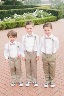 three young boys in formal clothes standing next to each other on a red brick walkway